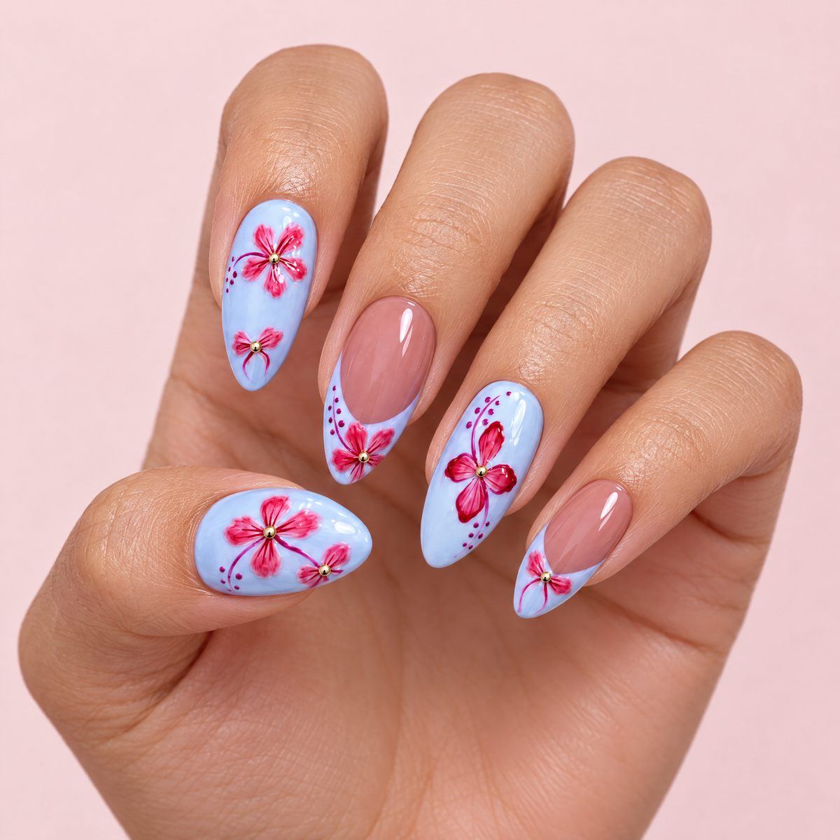 Pastel Blue Floral Almond Press On Nails worn on a hand