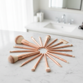 10-piece rose gold makeup brush set fanned out on marble